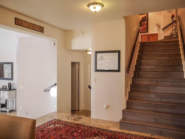 A living room with stairs leading up to the second floor