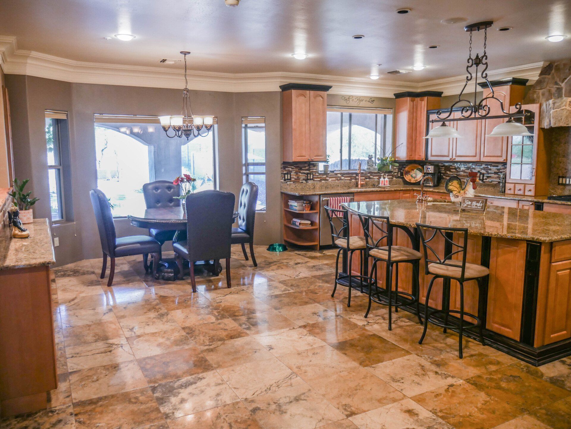 A kitchen and dining room in a house with a table and chairs.