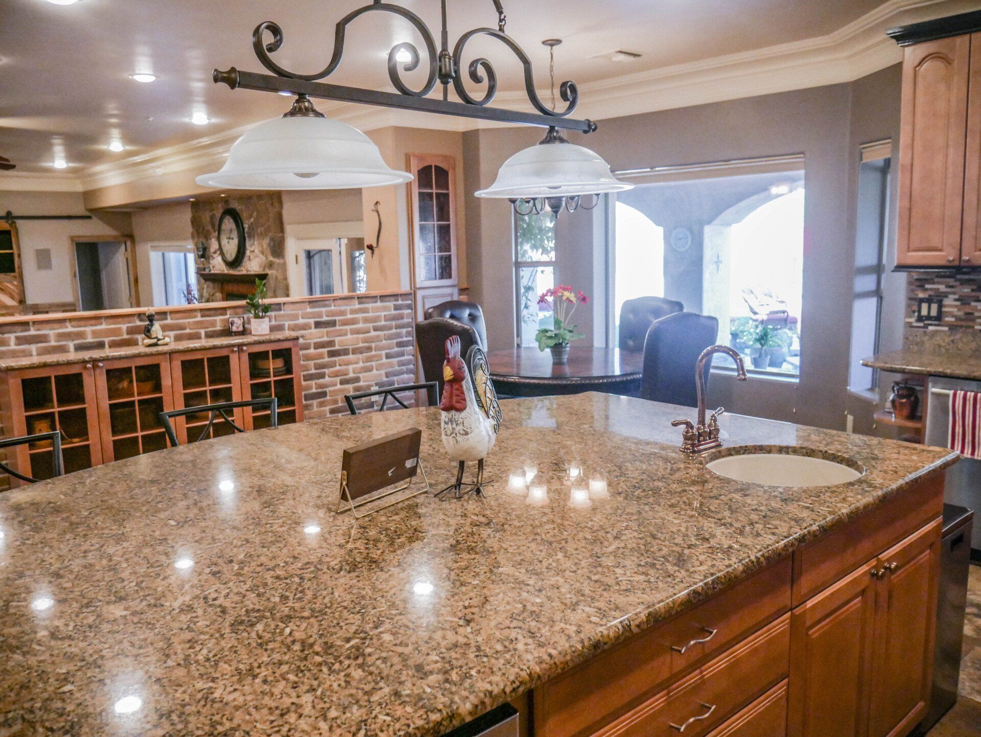A kitchen with a large granite counter top and a sink.