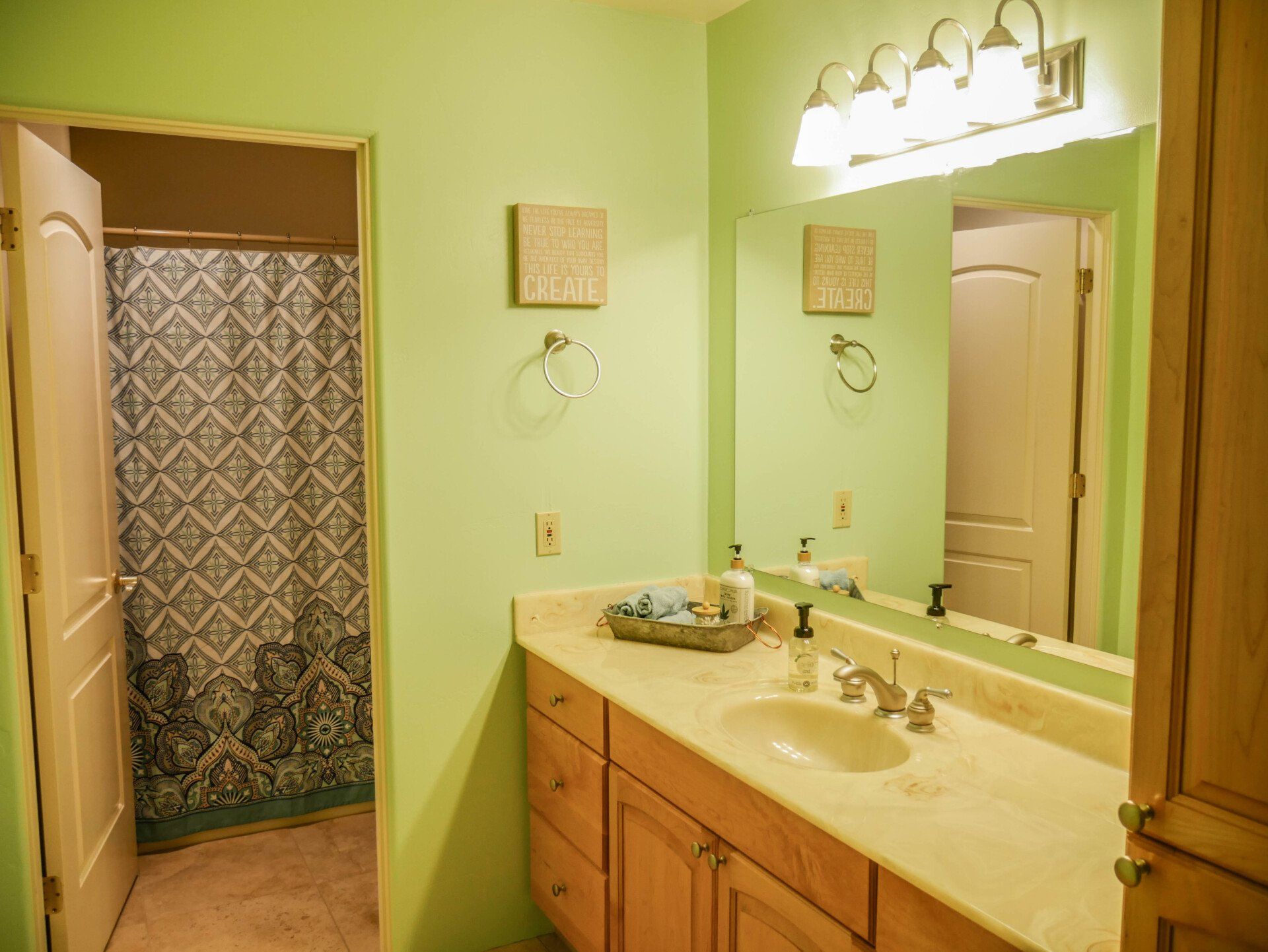 A bathroom with two sinks , a mirror and a shower.