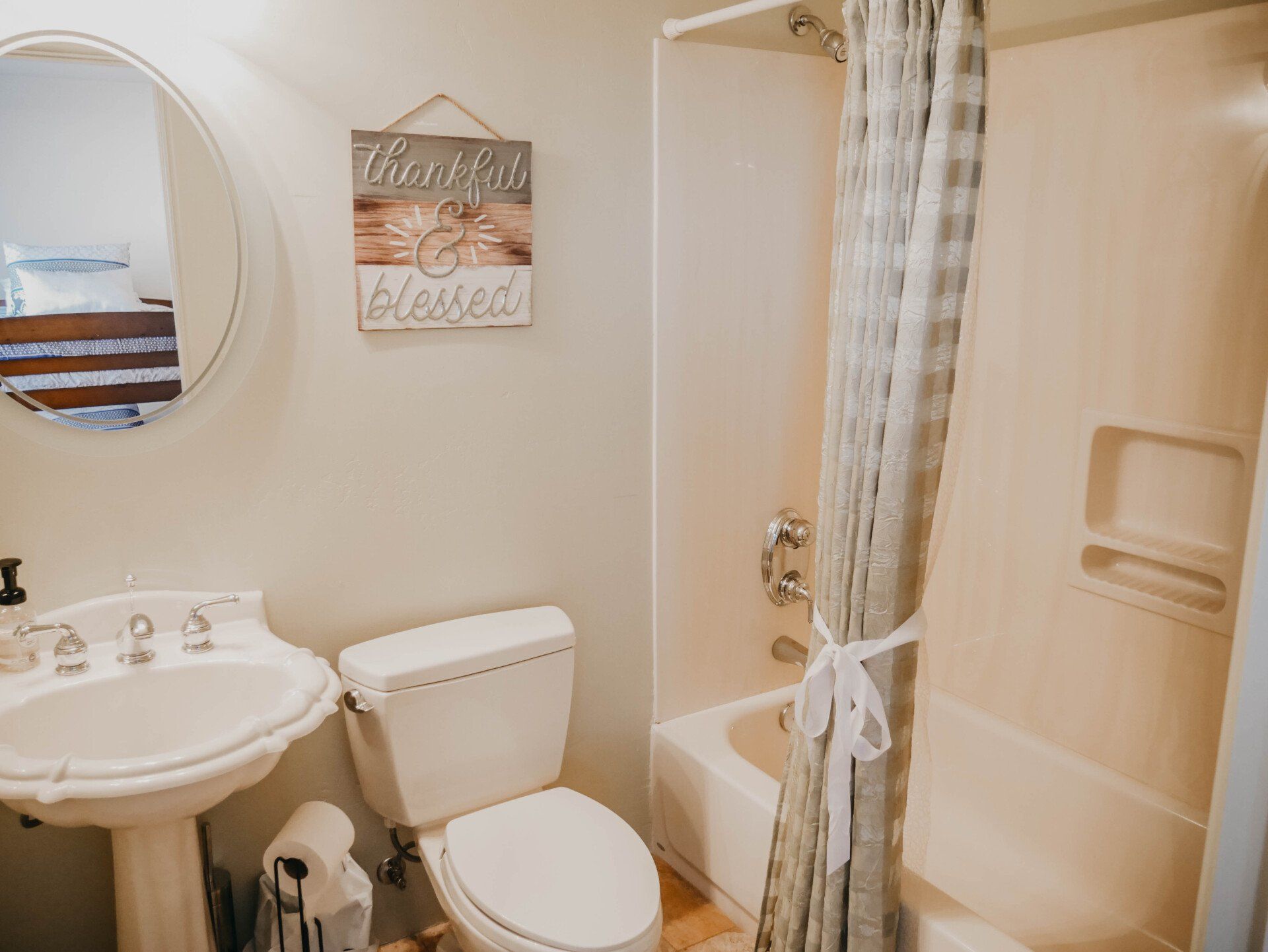 A bathroom with a toilet , sink , shower and bathtub.