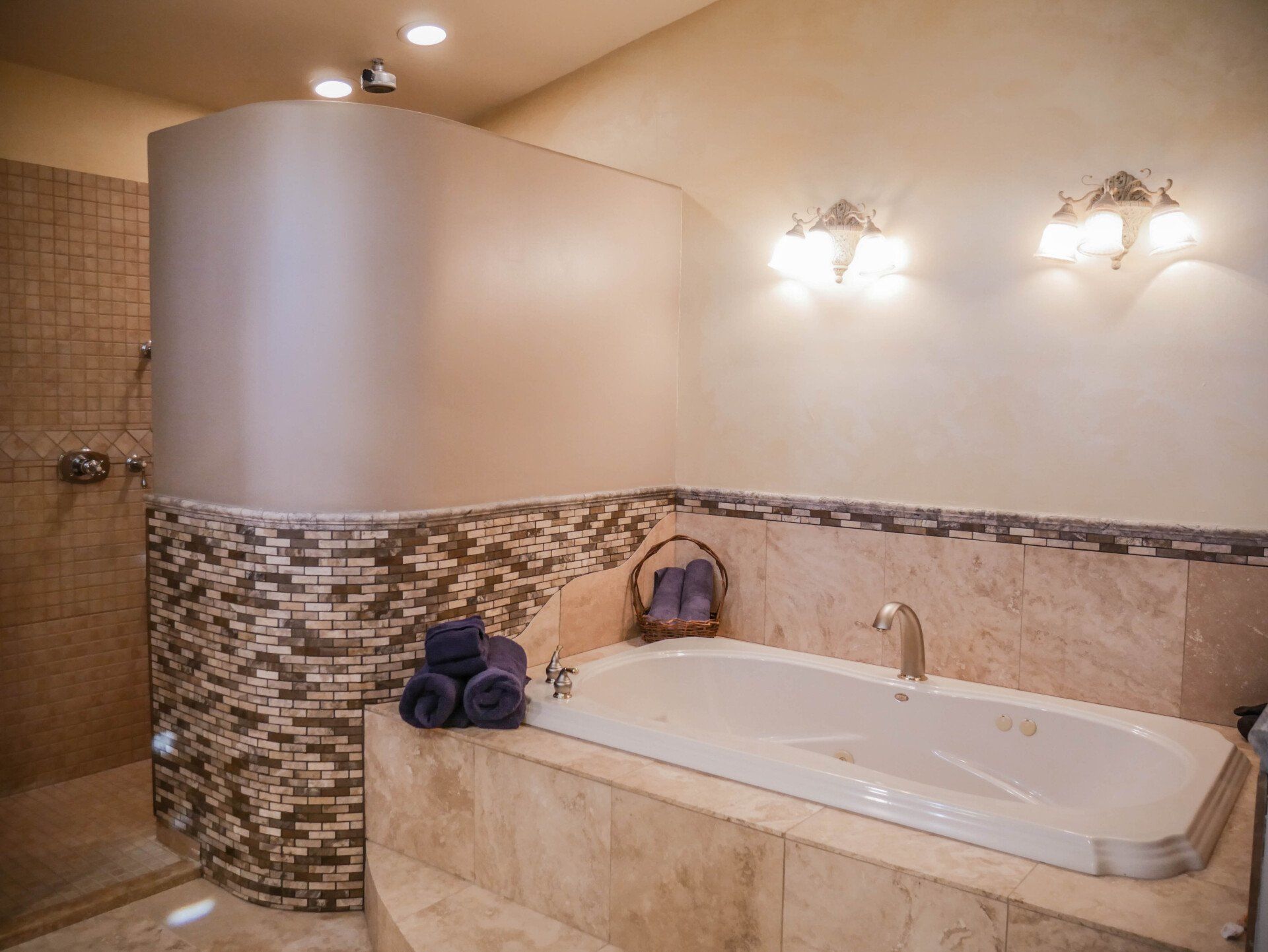 A bathroom with a bathtub and a walk in shower.