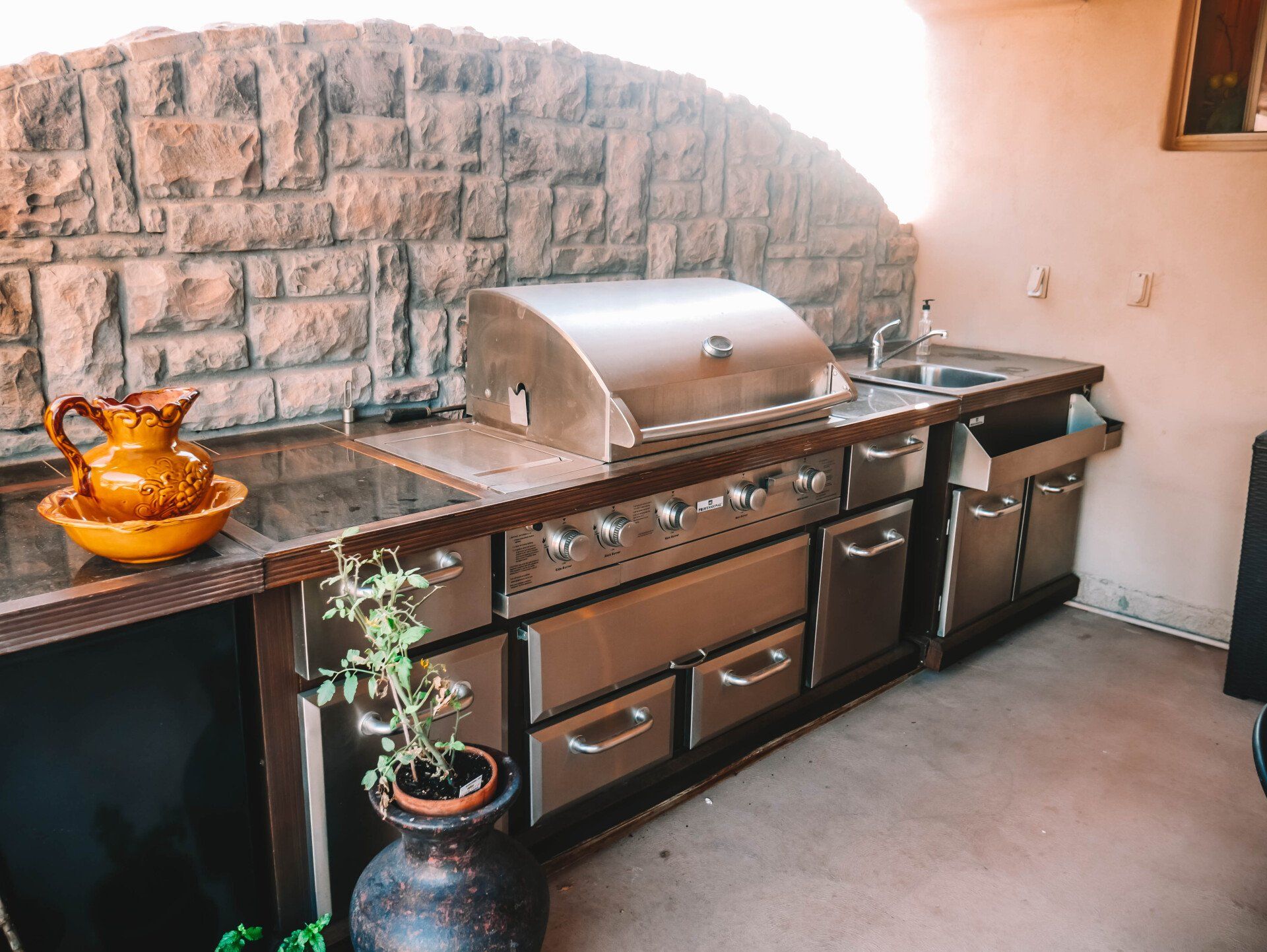 A kitchen with stainless steel appliances and a grill.