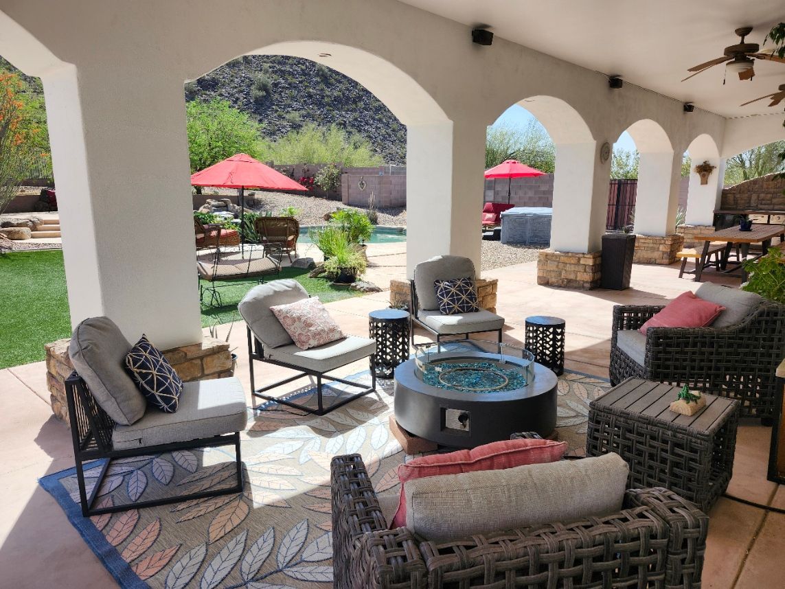 There is a large swimming pool in the backyard of a house.