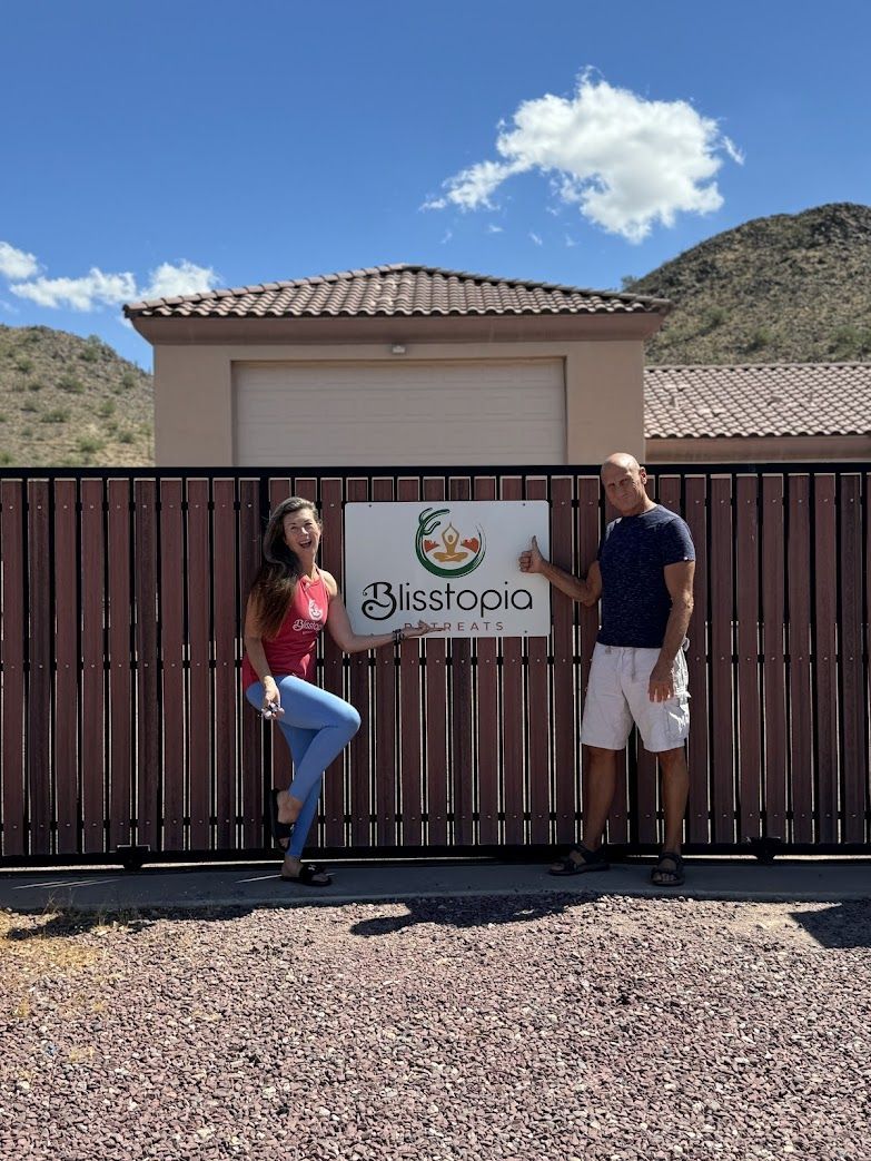 A man and a woman standing in front of a fence with a sign that says 25m spa