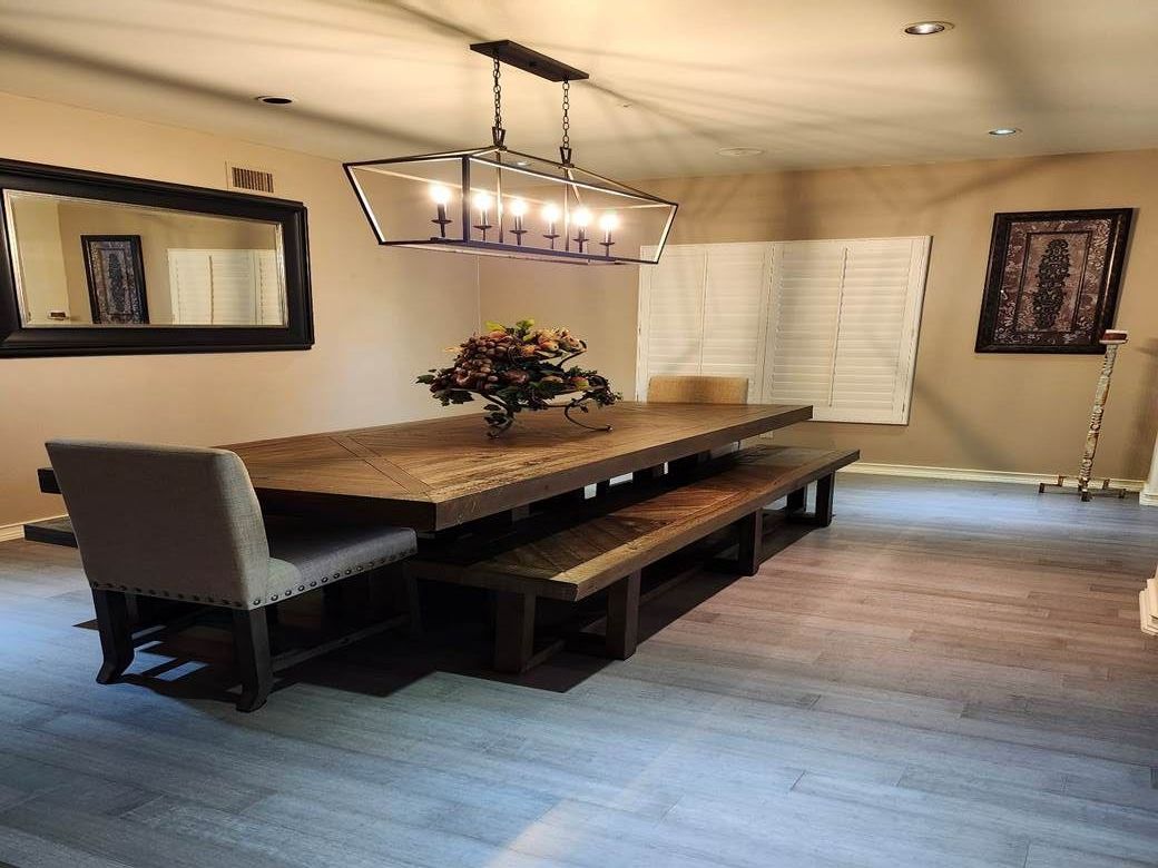A dining room with a long wooden table and benches