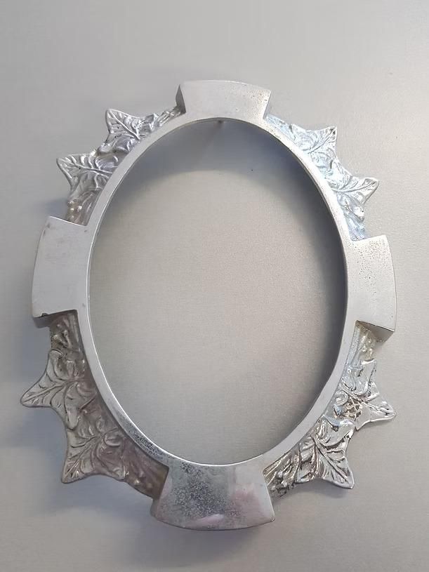 A Silver Picture Frame With a Cross on It is Sitting on a Table — Mackay Monumental Masons In Glenella, QLD