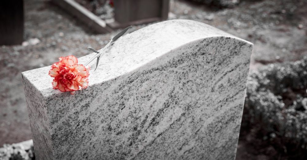 Headstones In Mackay With Engraved Memorial And Red Flower