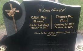 Black tombstone with gold text honoring Colleen Day (1935-2020) and Thomas Day (1932-2009). Cross and hands praying emblem.