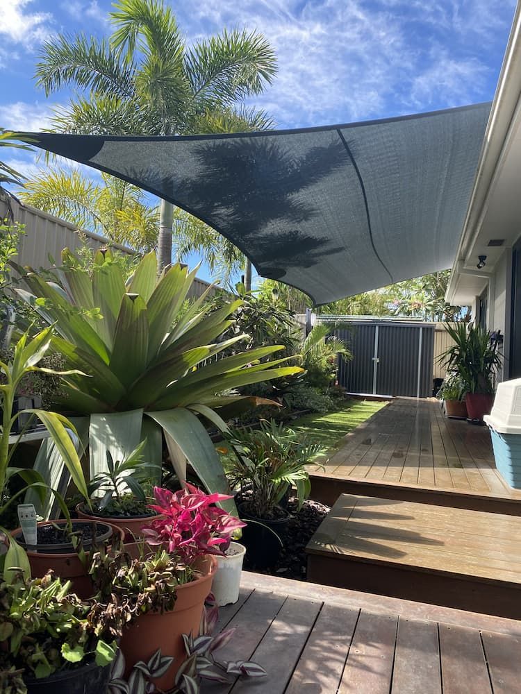 There Is A Shade Sail In The Backyard Of A House — SPF Shades and Sails in Byron Bay, NSW
