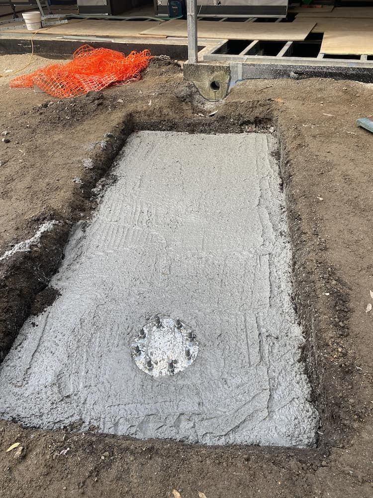 A Concrete Slab Is Being Poured Into A Hole In The Ground — SPF Shades and Sails in Tweed Heads West, NSW