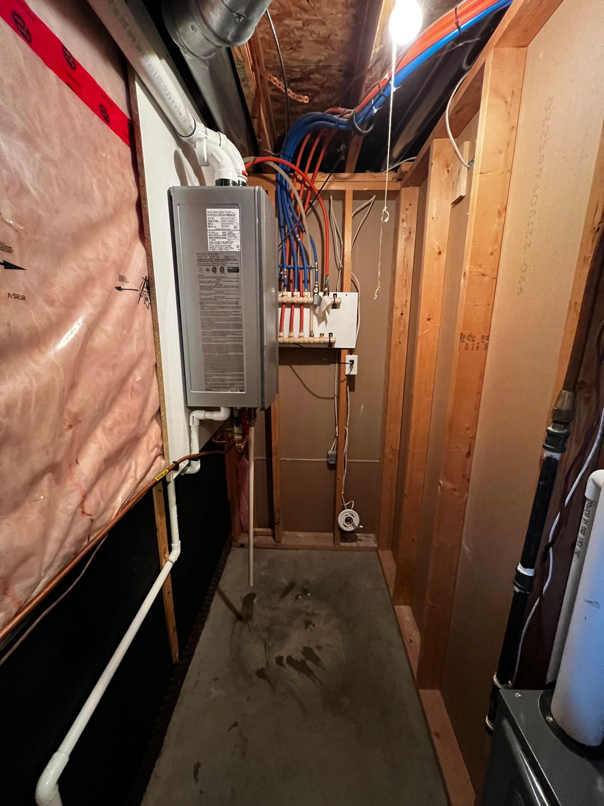 A hallway in a house with a heater on the wall