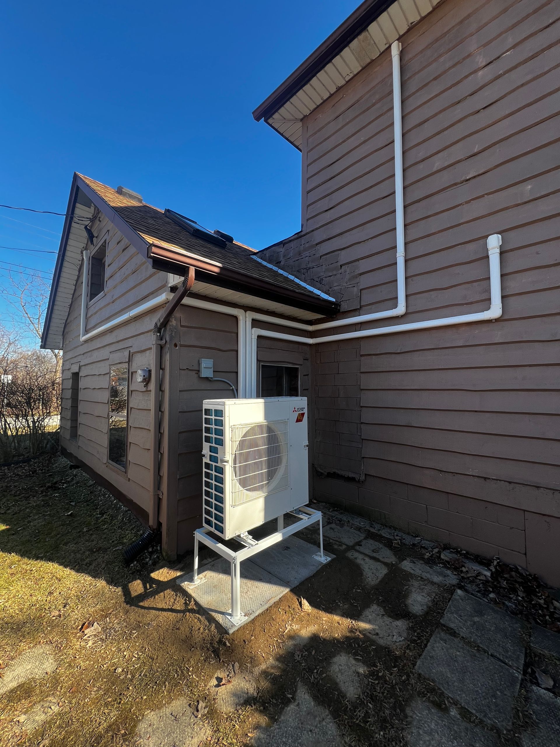 A house with a heater on the side of it