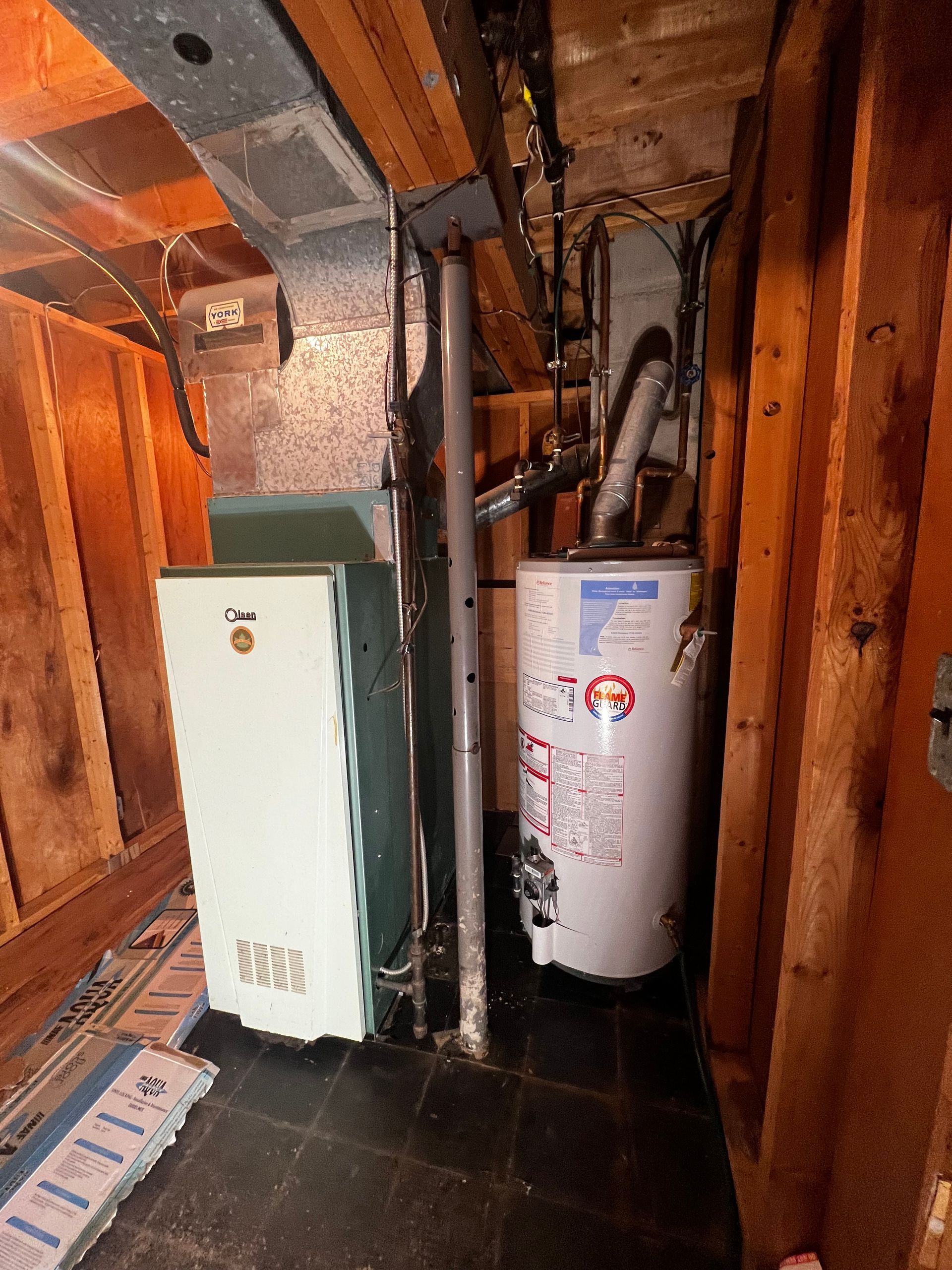 A room with a heater and a water heater in it