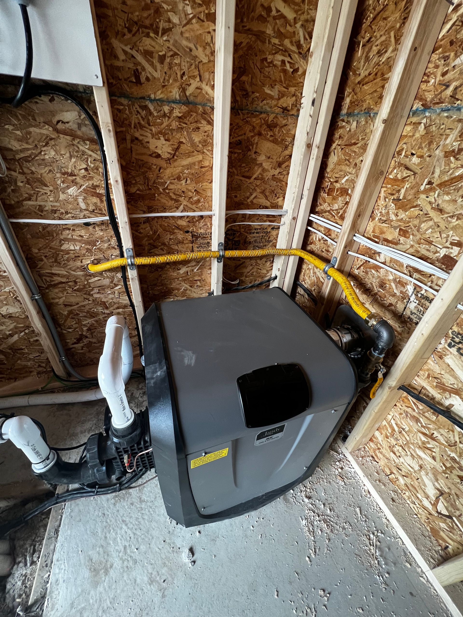 A water softener is sitting in the corner of a room.