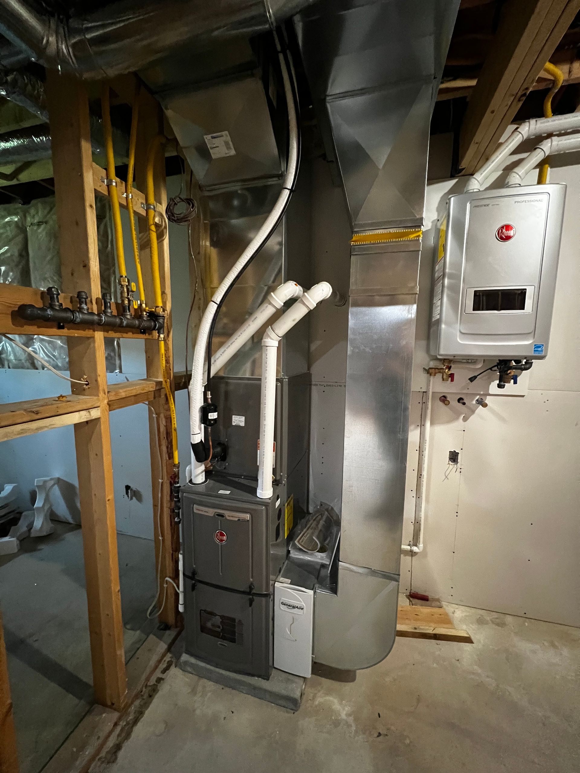 A basement with a furnace and a water heater.