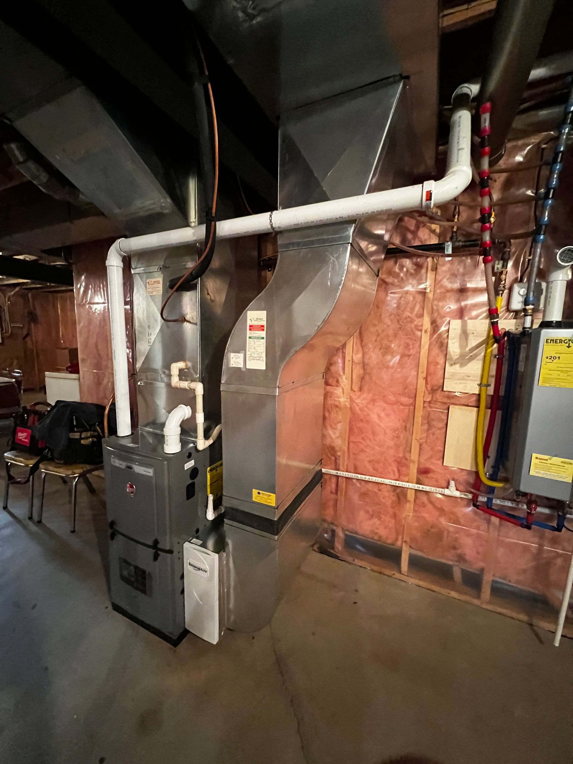 A basement with a furnace and a heater in it.