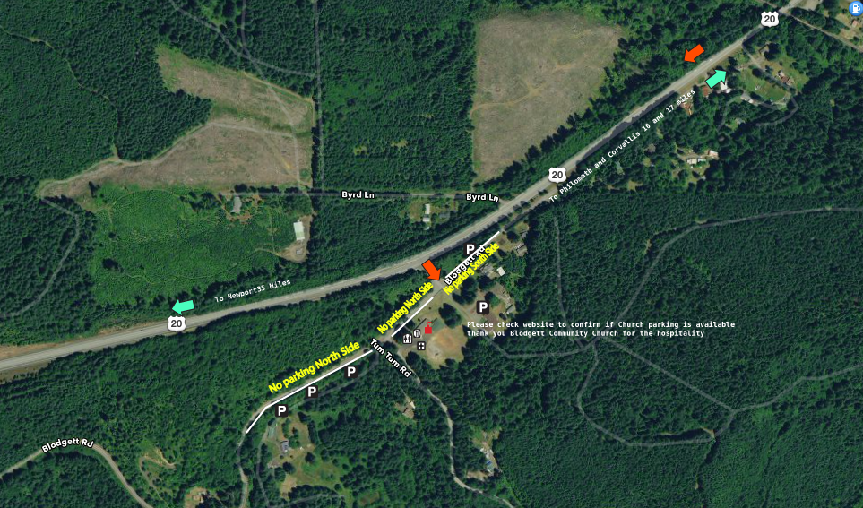 An aerial view of a highway surrounded by trees and fields.