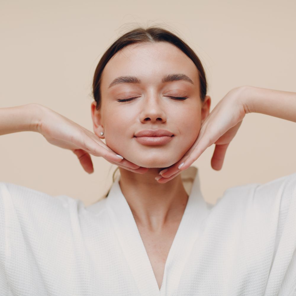 Nurse practitioner assessing facial skin under magnification before a rejuvenation treatment
