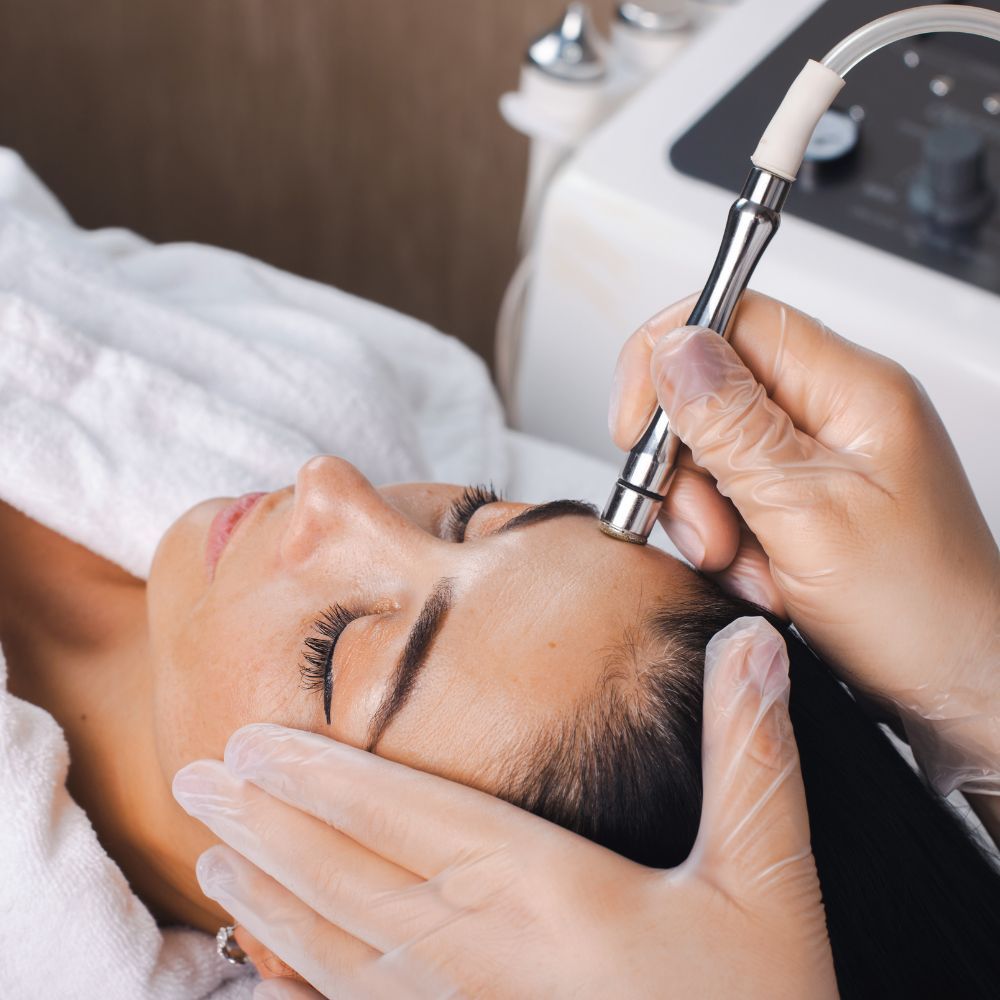 Microneedling being performed on the cheek during a planned facial rejuvenation course