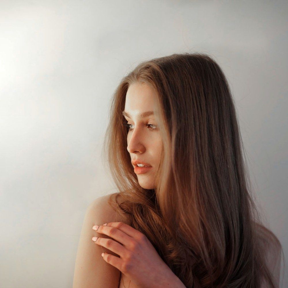 Part line being examined closely during a hair loss consultation