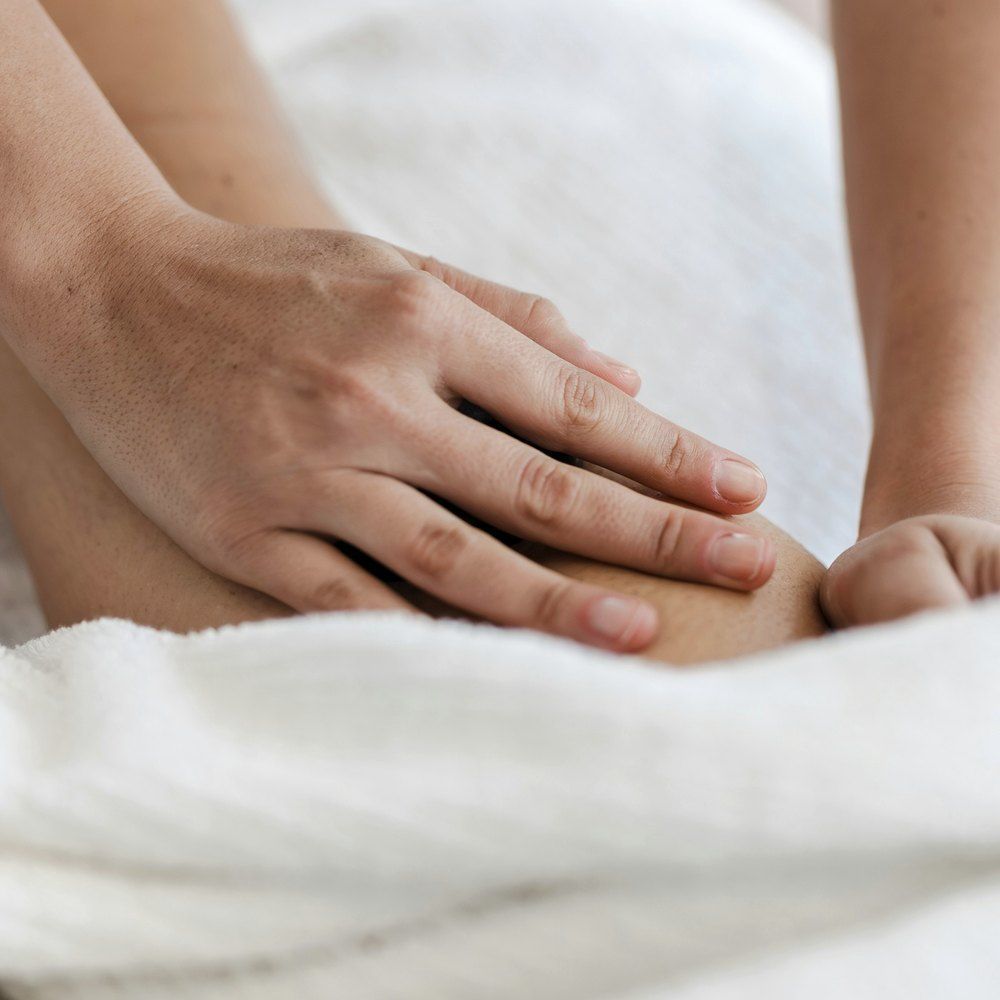 Hands working slowly along the back during a recovery focused massage at AgeSmart