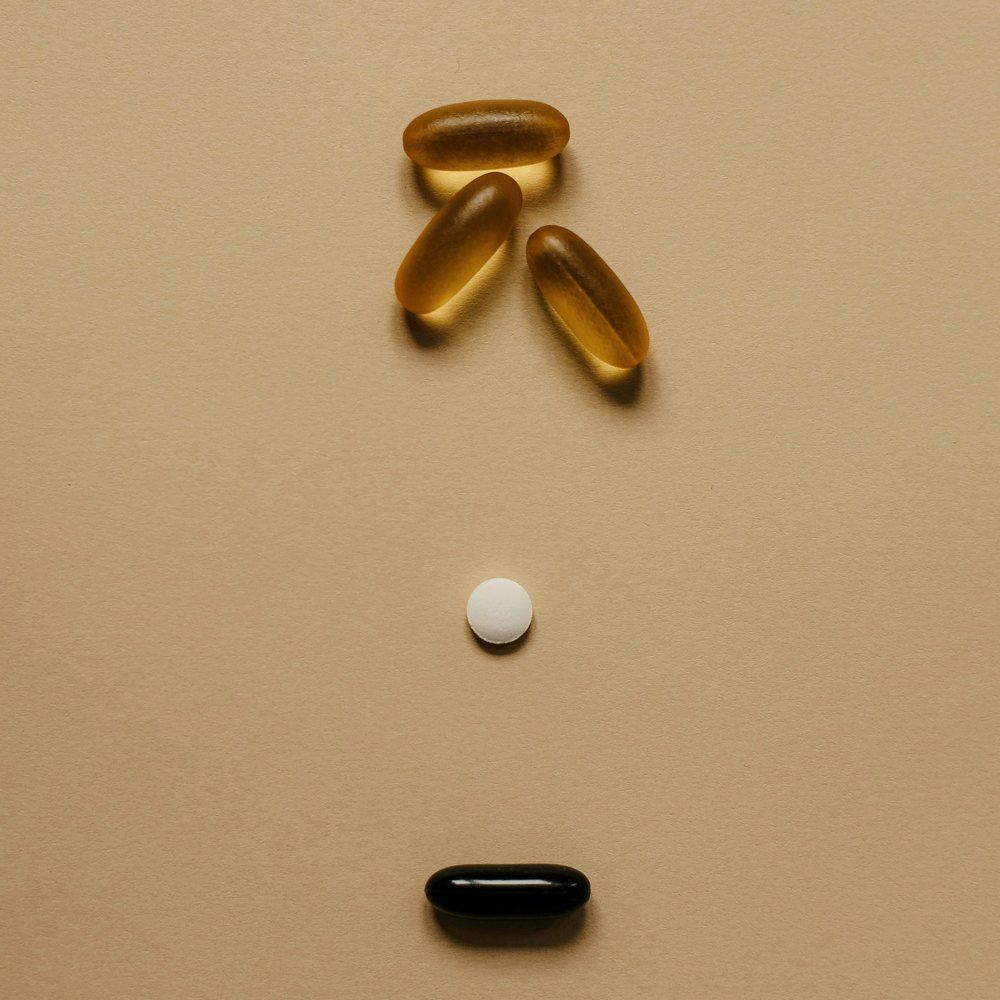 A clinician reviewing a printed medication list with a patient at a desk before preparing an infusion.