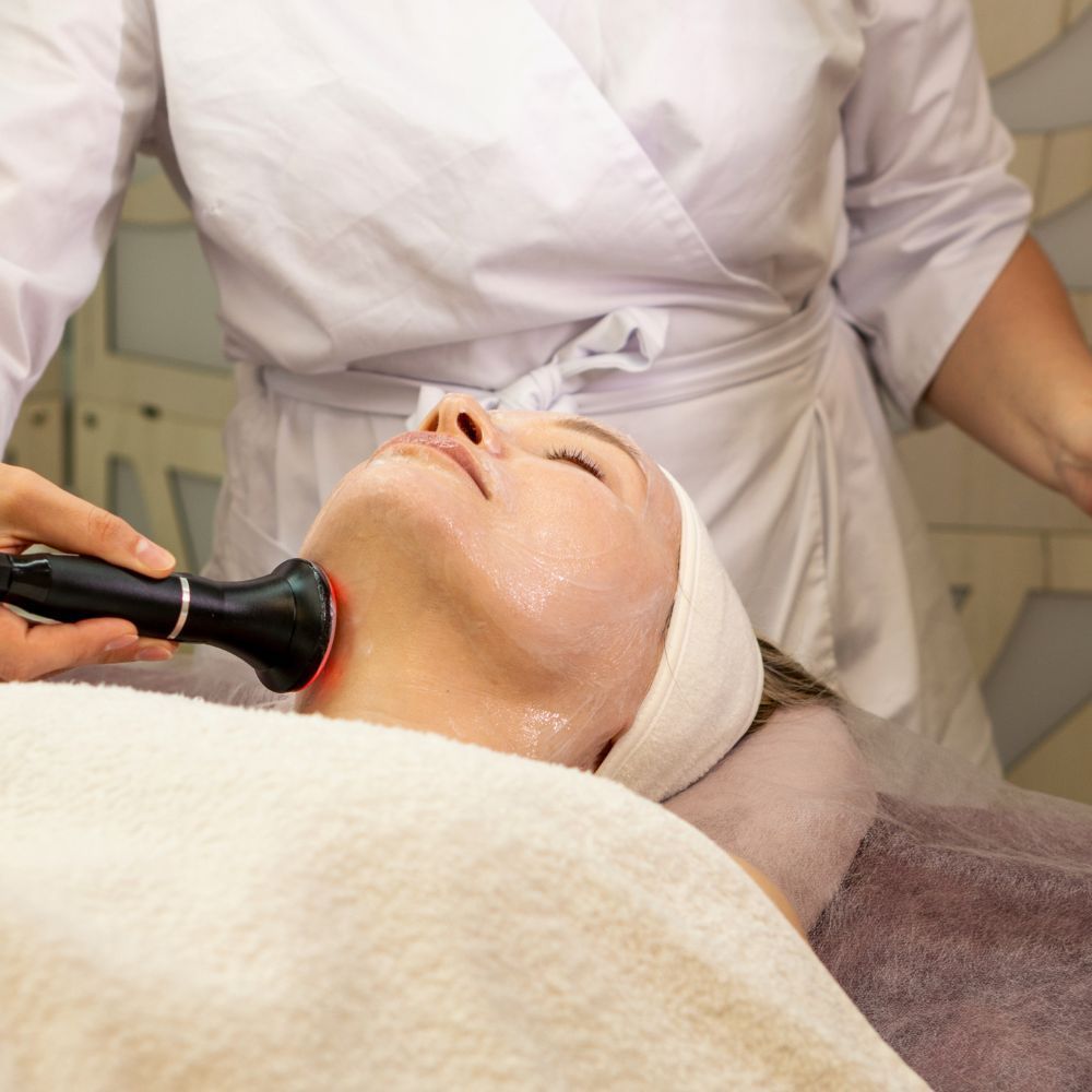 Gentle treatment being performed along the neck at reduced intensity