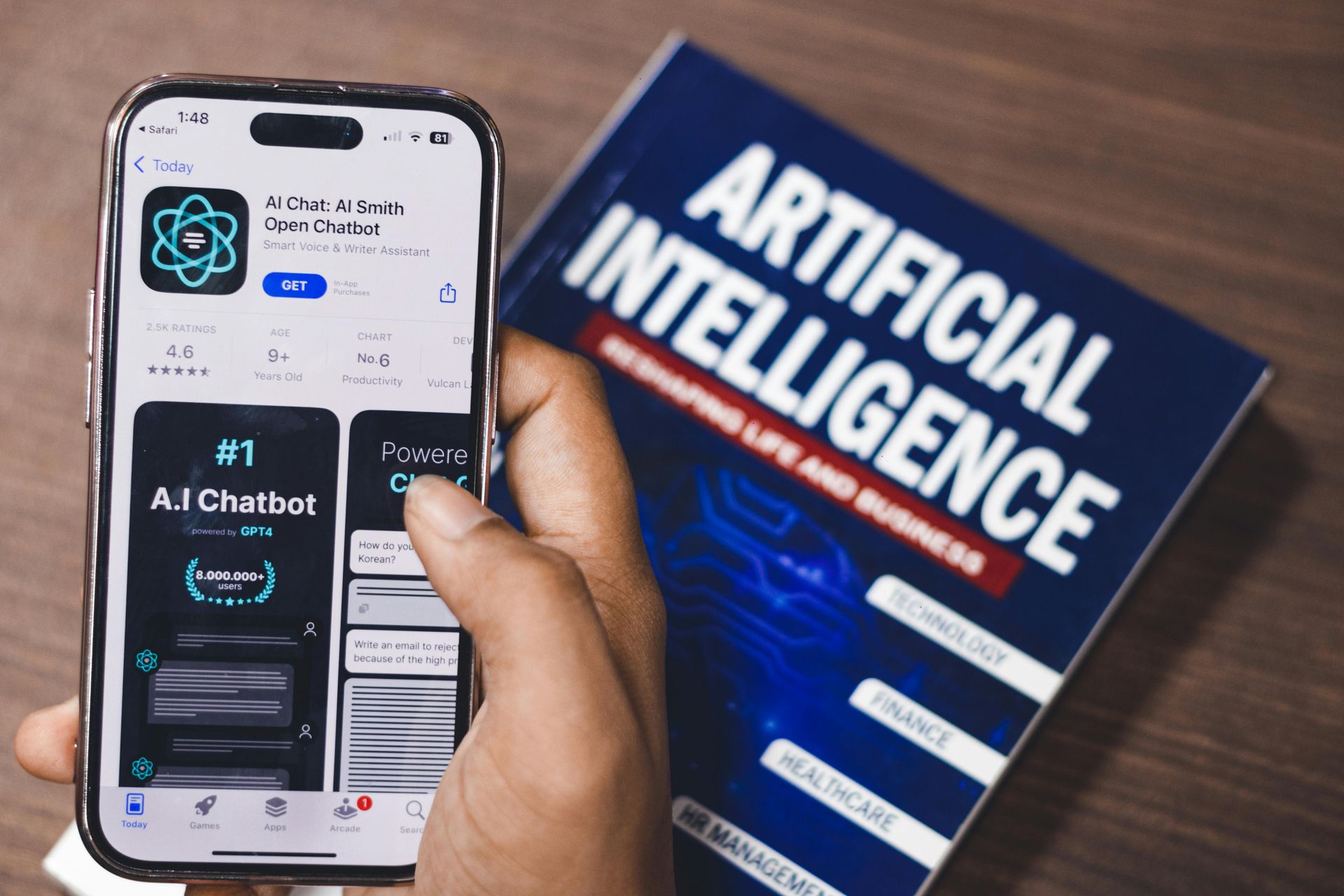 A hand holding a smartphone displaying an AI chatbot app next to an 