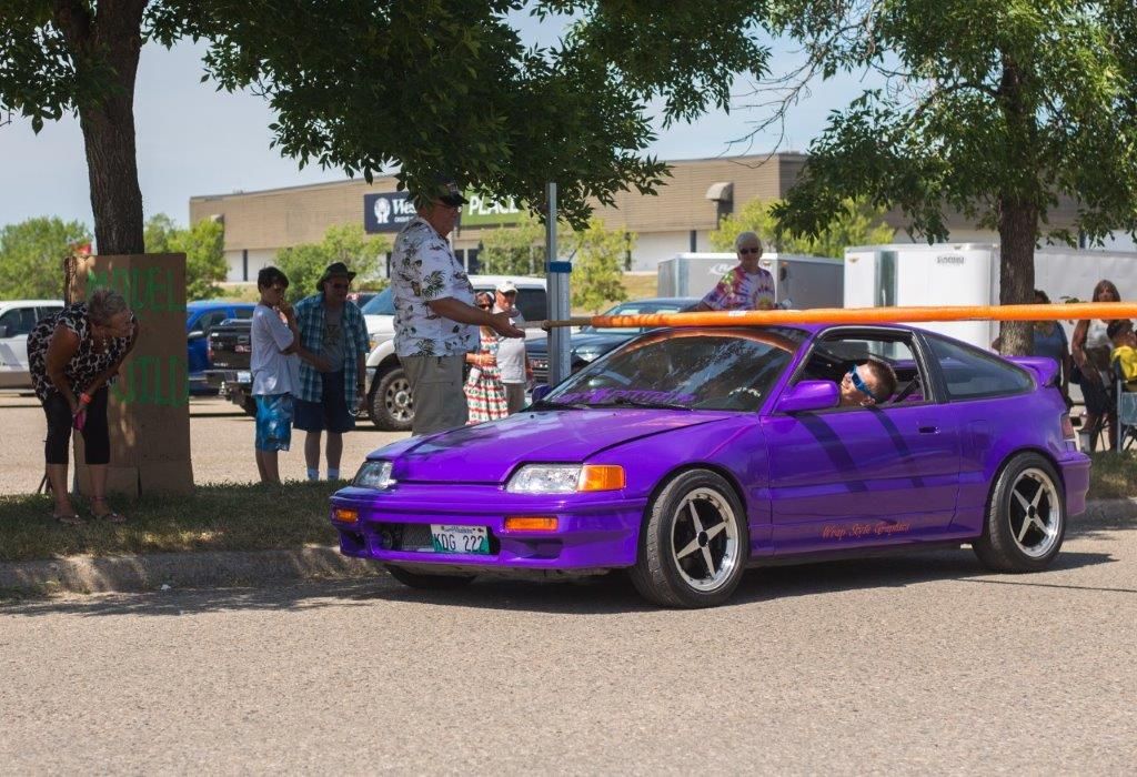 A purple honda crx is parked in a parking lot
