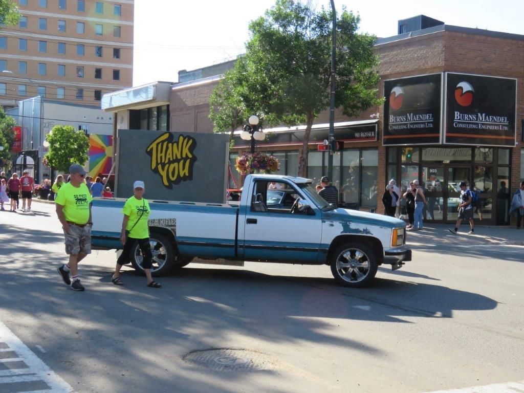 A truck with a sign on the back that says thank you