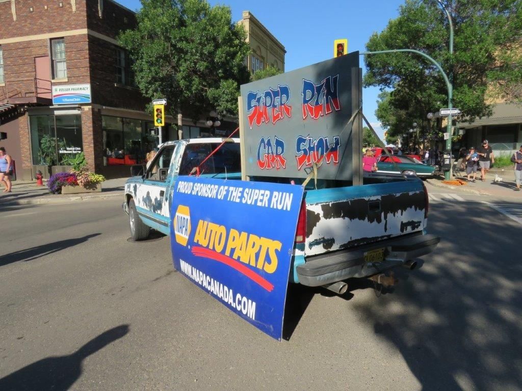 A truck with a sign on the back that says auto parts