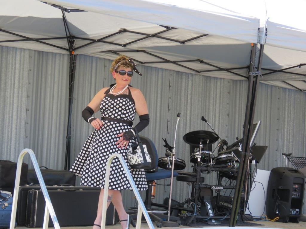 A woman in a black and white dress is standing on a stage
