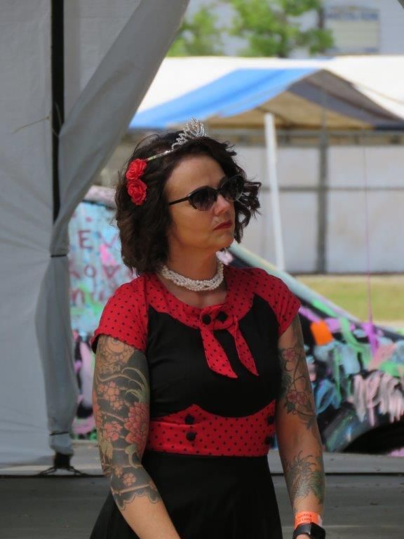 A woman in a red and black dress has a flower in her hair