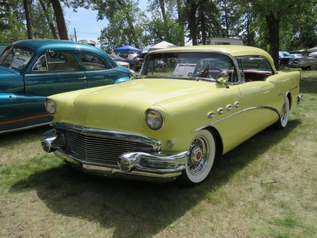 A yellow car is parked next to a blue car