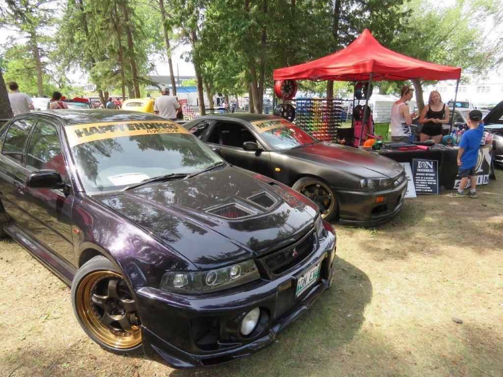A couple of cars parked next to each other in a park.