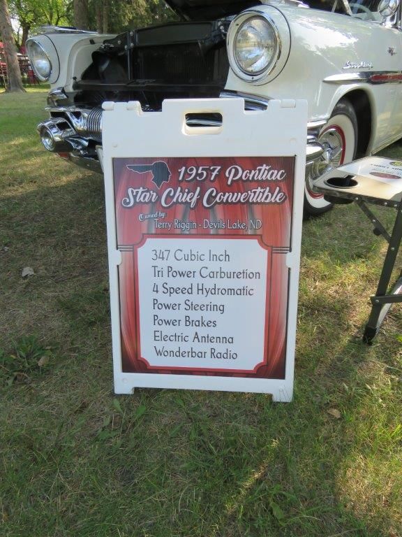 A sign for a 1957 pontiac star chief convertible