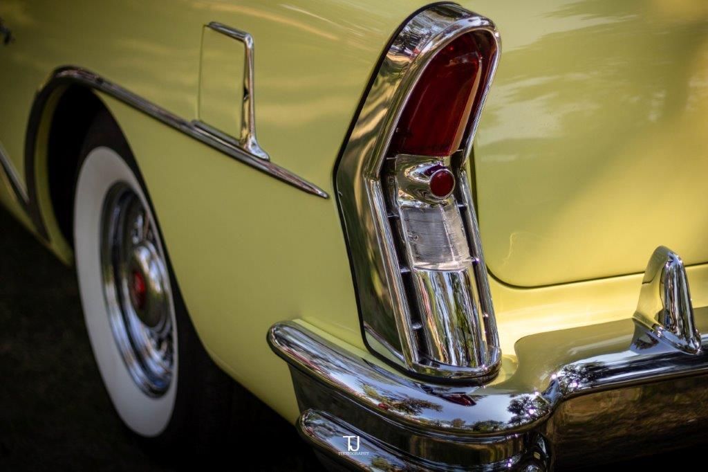 A close up of a yellow car 's tail light.