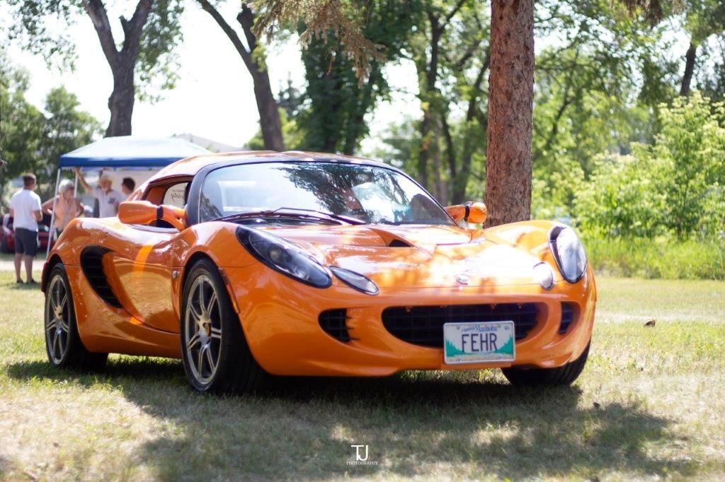 An orange sports car with a texas license plate