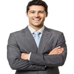 Man in gray pinstripe suit with arms crossed, smiling.