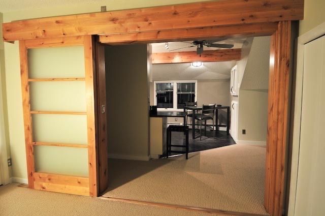 A rustic wooden sliding door with frosted glass panels opens into an interior dining area with a table and stools.