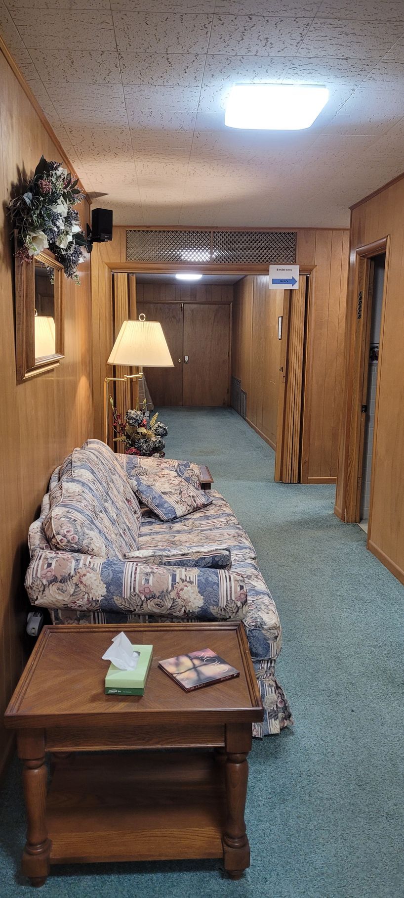 There is a couch and a table in the hallway.