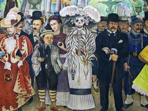 Group of elegantly dressed people in colorful costumes standing in front of a painted mural