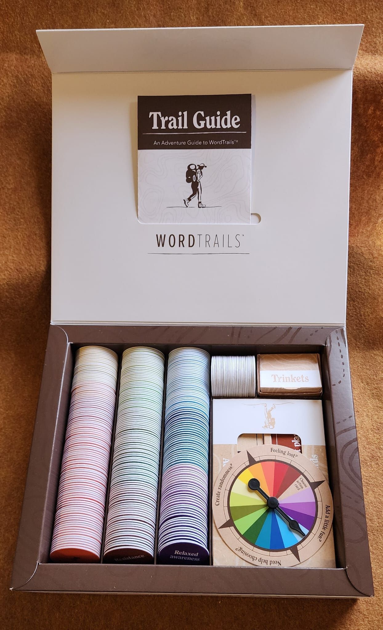 Open box of Trail Guide paint set with pastel color tubes, booklet, and color wheel inside