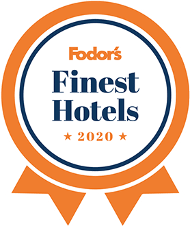 Fodor’s Finest Hotels 2020 award badge in orange, blue, and white