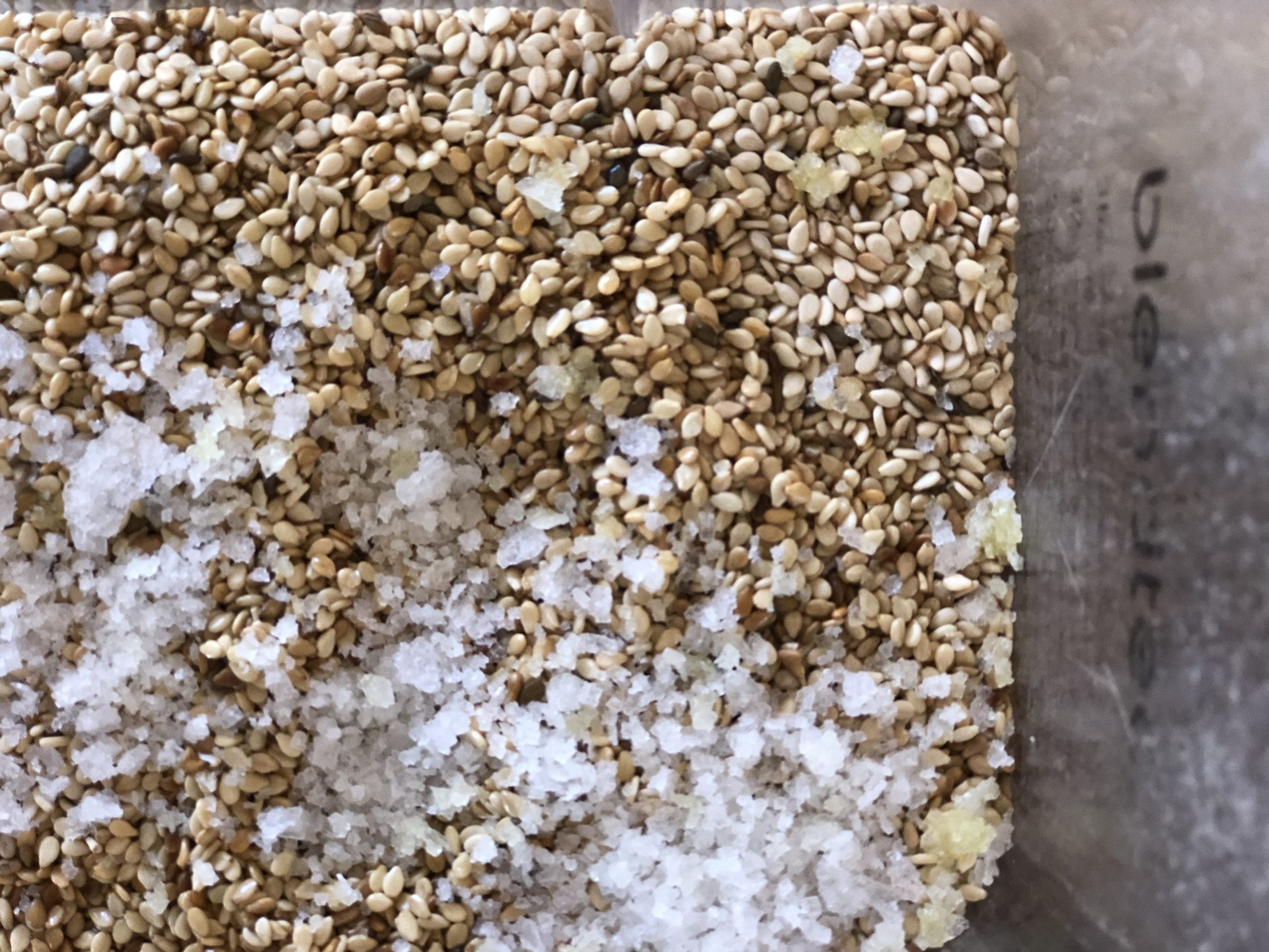 Close-up of a tan and white textured surface with granular material on the left side