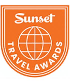 Orange Sunset Travel Awards logo with white globe and text