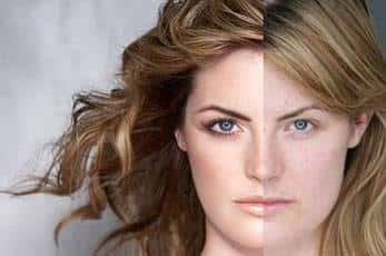 Split portrait of a woman with half dark, half blonde hair against a light background