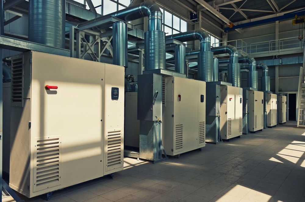 A Row Of Electrical Boxes Are Lined Up In A Factory — Wylec In Newcastle, NSW