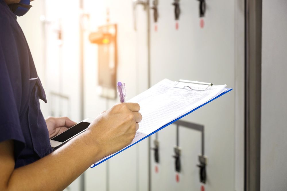 A Person Is Holding A Clipboard And Writing On It — Wylec In Mayfield West, NSW